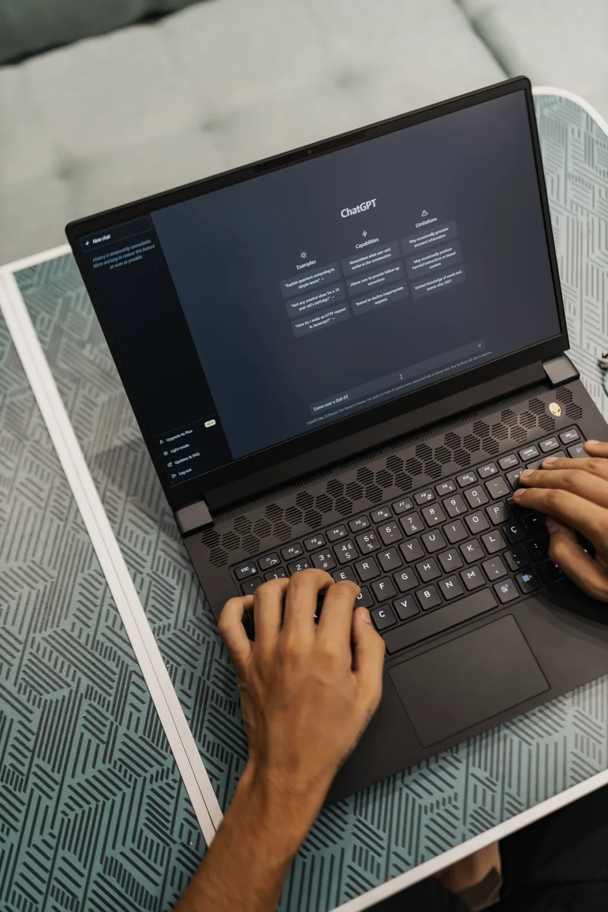 A person using ChatGPT on a laptop